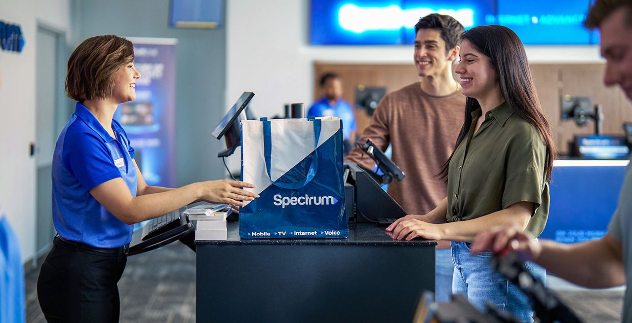 Spectrum Mobile store employee helping customers